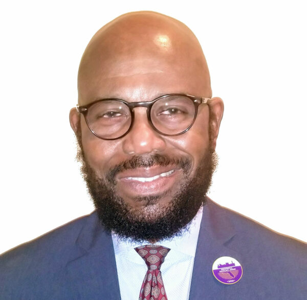 Commissioner Viegbesie proudly wears the limited-edition lapel pin awarded to him by the FAC as a recipient of the 2020 Presidential advocacy Award.